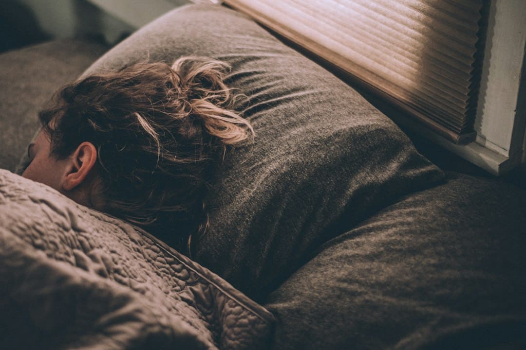 a girl sleeping in cozy couch with sun light coming in through window