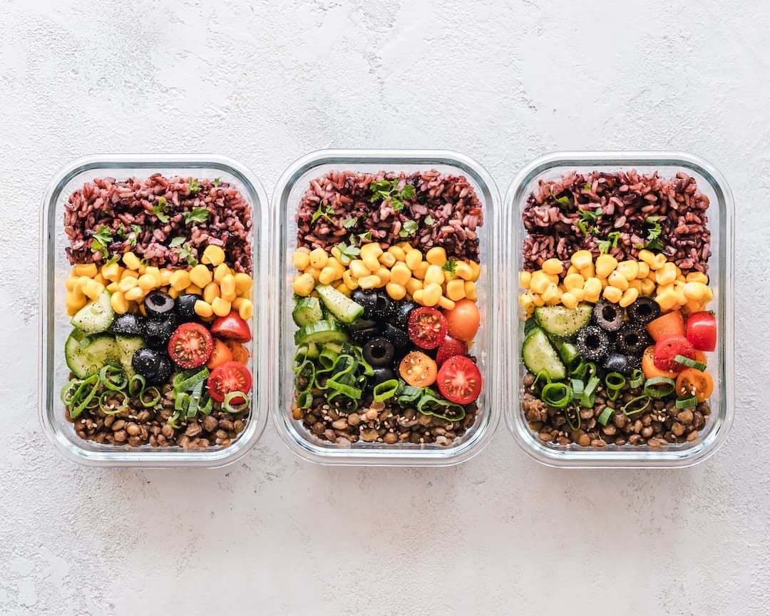 three containers full of different kinds of salads